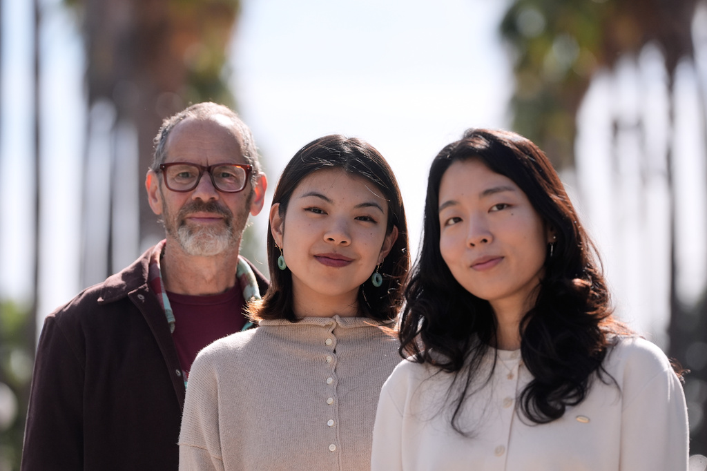 Dan Jurafsky, Stanford professor of computer science and linguistics, from left, Myra Cheng, Stanford Ph.D. candidate in computer science, and Cinoo Lee, Stanford postdoctoral fellow in psychology, pose for photos on the university campus in Stanford, Calif., Thursday, March 26, 2026. (AP Photo/Jeff Chiu)