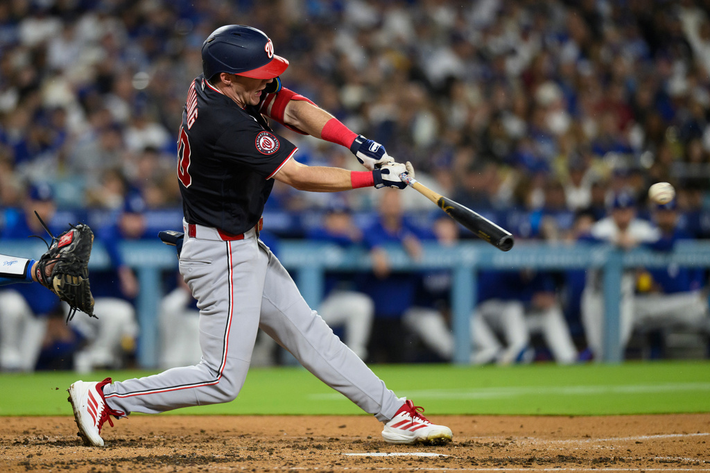 Washington Nationals' Jacob Young hits an RBI single during the fourth inning of a baseball game against the Los Angeles Dodgers in Los Angeles, Sunday, Sept. 6, 2026. (AP Photo/Kyusung Gong)