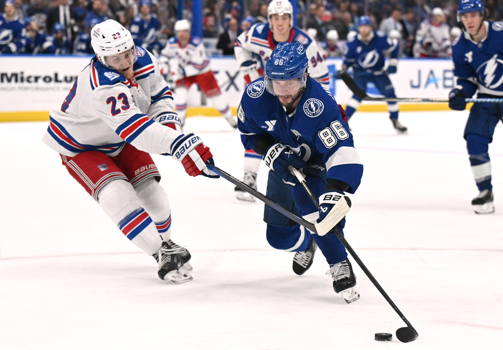 Tampa Bay Lightning right wing Nikita Kucherov (86) handles the puck against New York Rangers defenseman Adam Fox (23) during the second period of an NHL hockey game Wednesday, Nov. 12, 2025, in Tampa, Fla. (AP Photo/Jason Behnken)