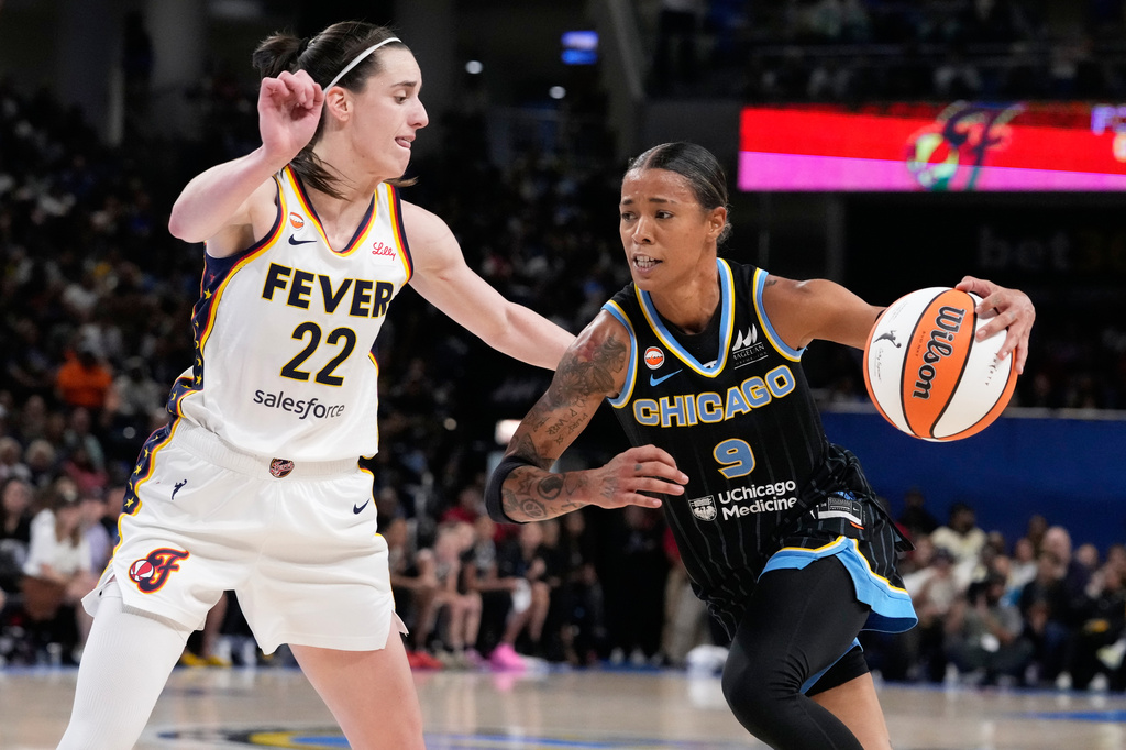 Chicago Sky guard Natasha Cloud, right, drives against Indiana Fever guard Caitlin Clark during the second half of a WNBA basketball game Sunday, Aug. 23, 2026, in Chicago. (AP Photo/Nam Y. Huh)