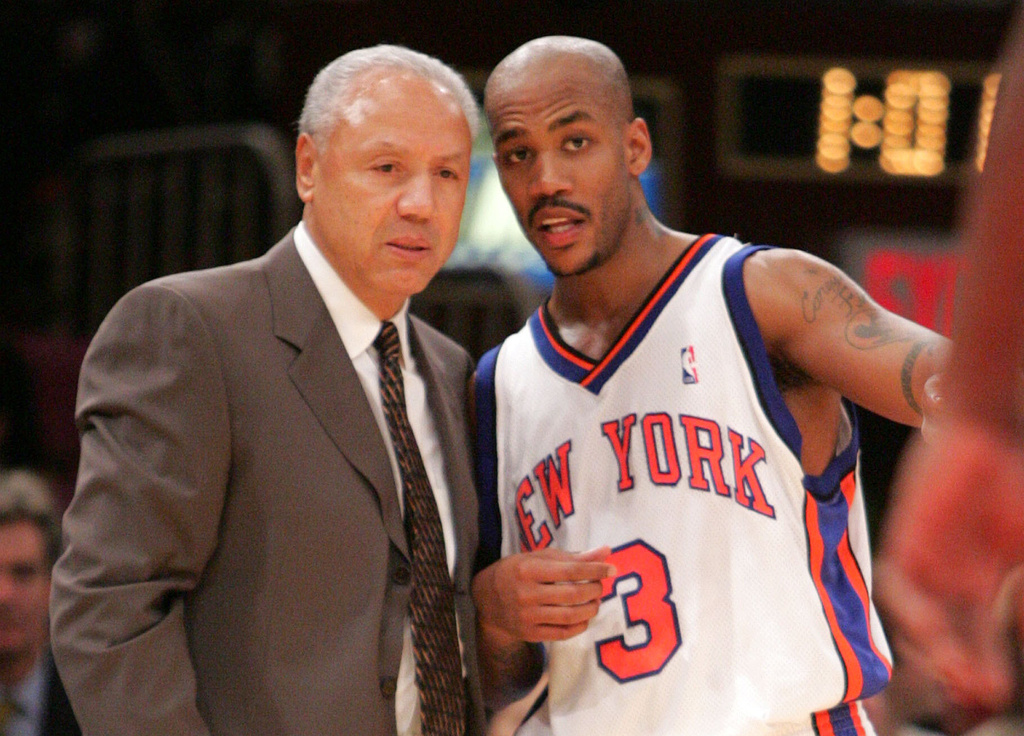 FILE - New York Knicks head coach Lenny Wilkens, left, talks with guard Stephon Marbury during the third quarter against of a basketball game against the Utah Jazz, Oct. 28, 2004 in New York. (AP Photo/Julie Jacobson, File)