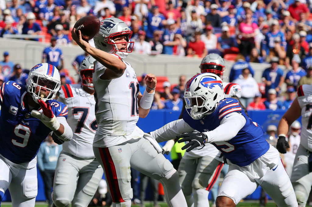 New England Patriots quarterback Drake Maye (10) passes against Buffalo Bills linebacker Greg Rousseau (15) in the second half during an NFL football game in Orchard Park, N.Y., Sunday, Oct. 4, 2026. (AP Photo/Jeffrey T. Barnes)