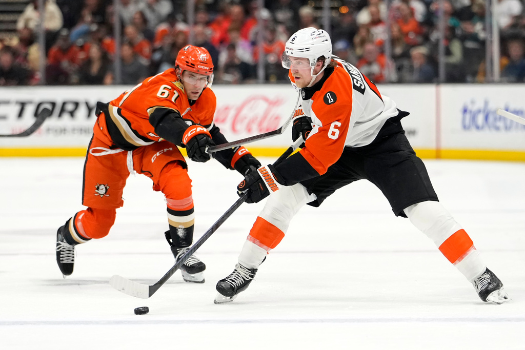 Anaheim Ducks left wing Cutter Gauthier, left, high sticks Philadelphia Flyers defenseman Travis Sanheim during the second period of an NHL hockey game Wednesday, March 18, 2026, in Anaheim, Calif. (AP Photo/Mark J. Terrill)