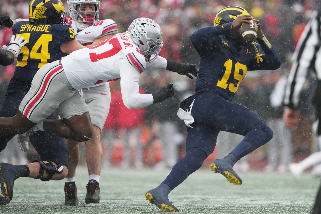 Ohio State defensive end Kenyatta Jackson Jr., left, sacks Michigan quarterback Bryce Underwood during the second half of an NCAA college football game, Saturday, Nov. 29, 2025, in Ann Arbor, Mich. (AP Photo/Ryan Sun)