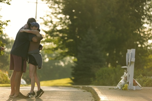 People hug as they visit at a memorial at Annunciation Catholic Church after Wednesday's school shooting, Thursday, Aug. 28, 2025, in Minneapolis. (AP Photo/Abbie Parr) People hug as they visit at a memorial at Annunciation Catholic Church after Wednesday's school shooting, Thursday, Aug. 28, 2025, in Minneapolis. (AP Photo/Abbie Parr)