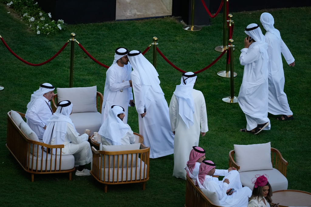 Racegoers gather at the Meydan Racecourse ahead of Dubai World Cup in Dubai, United Arab Emirates, Saturday, March 28, 2026. (AP Photo/Altaf Qadri)