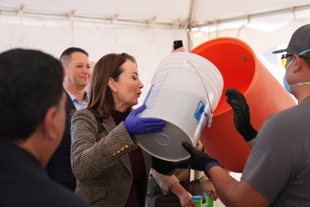 U.S. Secretary of Agriculture Brooke Rollins, center, places fly pupae into a container to be dyed following a ribbon-cutting ceremony for the grand opening of a Domestic New World Screwworm Sterile Fly Production Facility to combat the northward spread of NWS and protect American livestock, in Edinburg, Texas, Monday, Feb. 9, 2026. (AP Photo/Eric Gay)