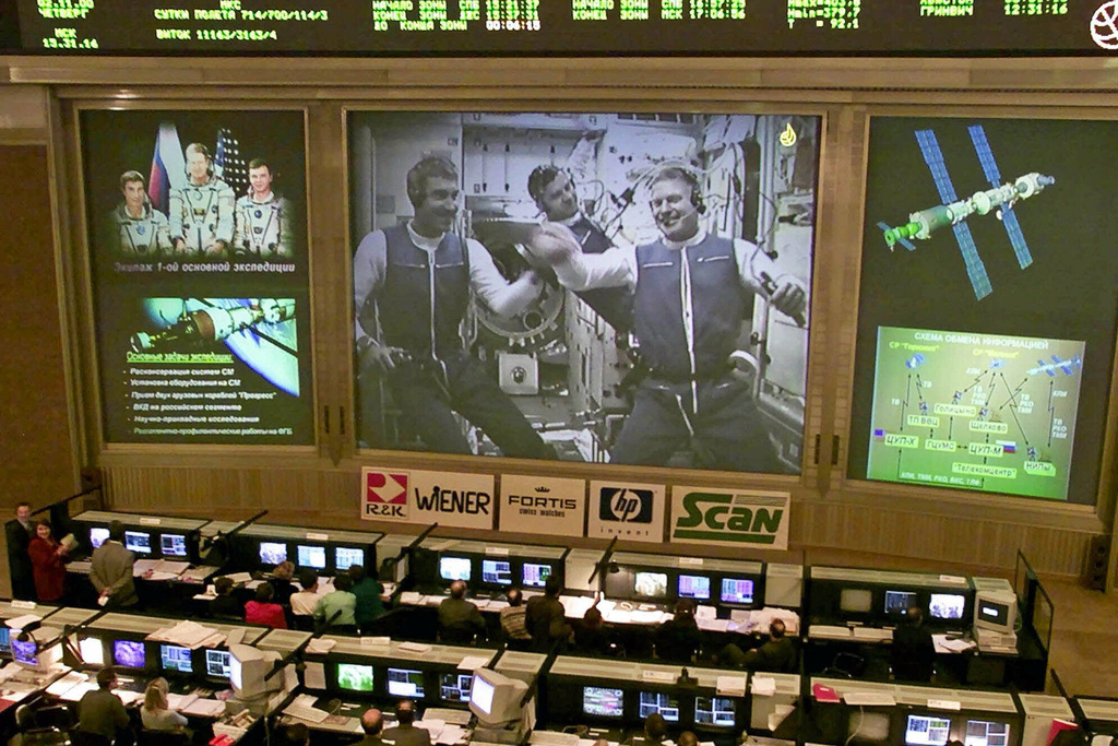 FILE - Russia's Mission Control center monitors the crew floating inside the International Space Station, from at Korolyov, just outside Moscow, Thursday, Nov. 2, 2000. The central screen shows American astronaut Bill Shepherd, right, Russian cosmonauts Yuri Gidzenko, center, and Sergei Krikalev, left. (AP Photo/Mikhail Metzel, File)