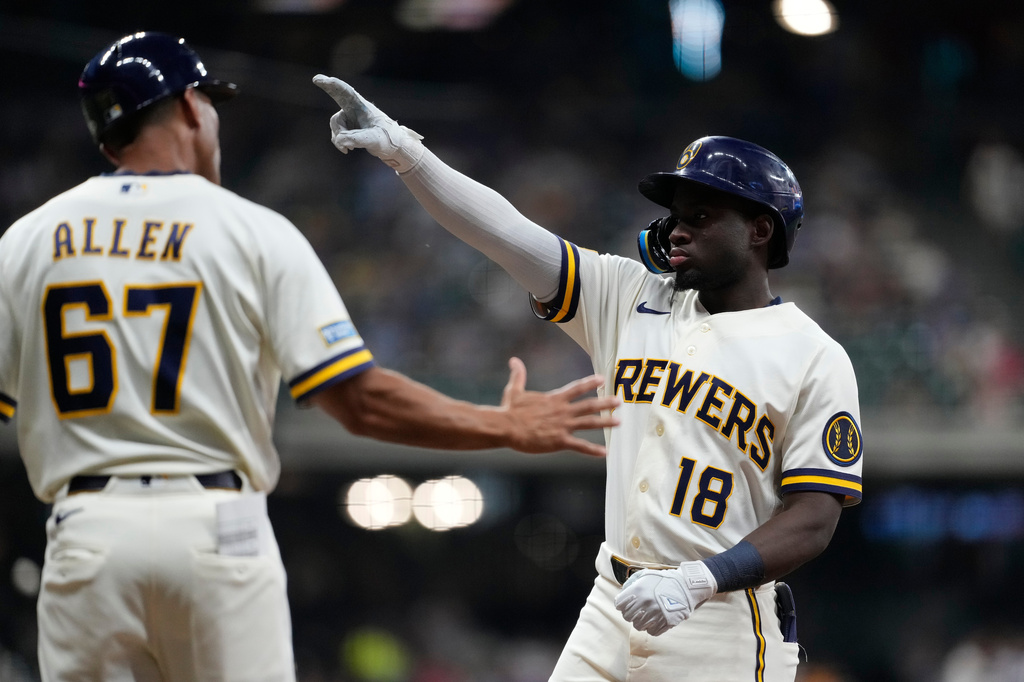 Milwaukee Brewers' Luis Lara (18) gestures after hitting an RBI single during the fifth inning of a baseball game against the Pittsburgh Pirates, Tuesday, Aug. 4, 2026, in Milwaukee. (AP Photo/Aaron Gash)