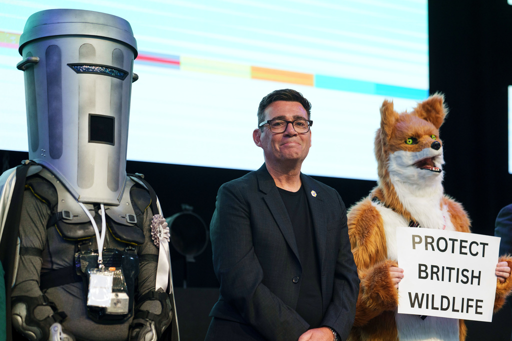Labour party's Andy Burnham stands beside candidate Count Binface, left, and a candidate for Protect British Wildlife after winning the Makerfield by-election, paving the way for a leadership challenge against Prime Minister Sir Keir Starmer. in Wigan, England, Friday, June 19, 2026.(AP Photo/Jon Super)