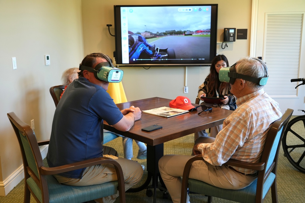 Mike Holtshouse and his father, Jim Holtshouse, watch video through Rendever virtual-reality headsets at the Forum at Rancho San Antonio retirement community in Cupertino, Calif. on June 11, 2025. (AP Photo/Terry Chea)