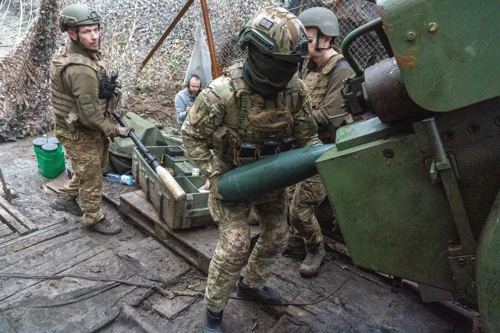 Soldiers from Ukraine's Khartia brigade fire a canon towards Russian army positions near Kharkiv, Ukraine, Thursday, May 14, 2026. (AP Photo/Andrii Marienko)