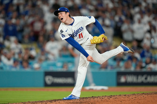 Los Angeles Dodgers relief pitcher Roki Sasaki throws to a Cincinnati Reds batter during the ninth inning in Game 2 of the National League Wild Card baseball playoff series Wednesday, Oct. 1, 2025, in Los Angeles. (AP Photo/Mark J. Terrill) Los Angeles Dodgers relief pitcher Roki Sasaki throws to a Cincinnati Reds batter during the ninth inning in Game 2 of the National League Wild Card baseball playoff series Wednesday, Oct. 1, 2025, in Los Angeles. (AP Photo/Mark J. Terrill)