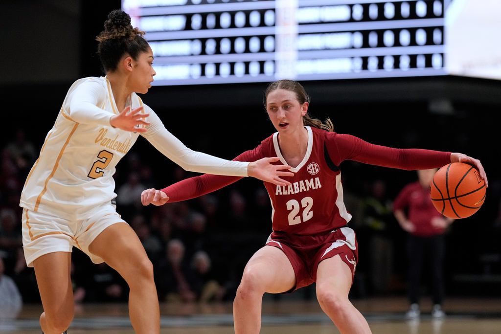 Alabama's Karly Weathers (22) moves the ball against Vanderbilt's Jada Brown (2) in the first half of an NCAA college basketball game Thursday, Feb. 26, 2026, in Nashville, Tenn. (AP Photo/Mark Humphrey)