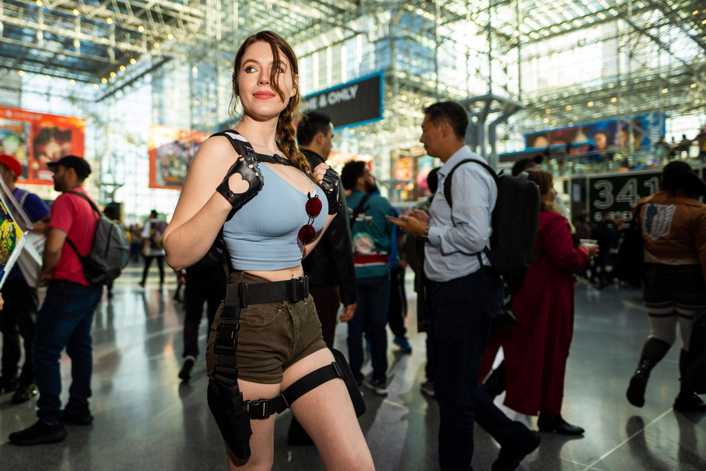 FILE - An attendee dressed as Lara Croft from Tomb Raider poses during New York Comic Con at the Jacob K. Javits Convention Center on Thursday, Oct. 12, 2023, in New York. (Charles Sykes/Invision/AP, File)