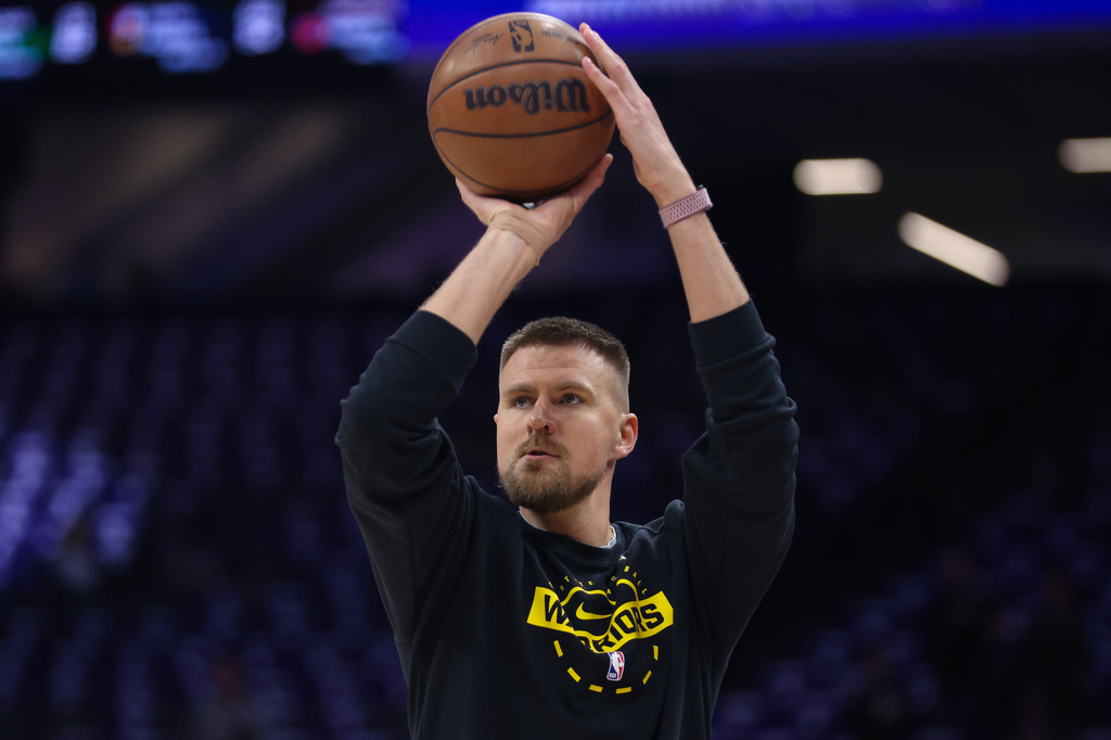 FILE - Golden State Warriors center Kristaps Porzingis warms up before an NBA basketball game against the Sacramento Kings, Friday, April 10, 2026, in Sacramento, Calif. (AP Photo/Scott Marshall, file)