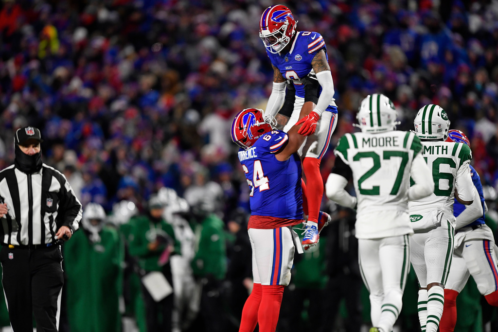 Buffalo Bills wide receiver Keon Coleman (0) is picked by guard O'Cyrus Torrence after Coleman caught a pass for a 2-point conversion against the New York Jets the second half of an NFL football game Sunday, Jan. 4, 2026, in Orchard Park, N.Y. (AP Photo/Adrian Kraus)