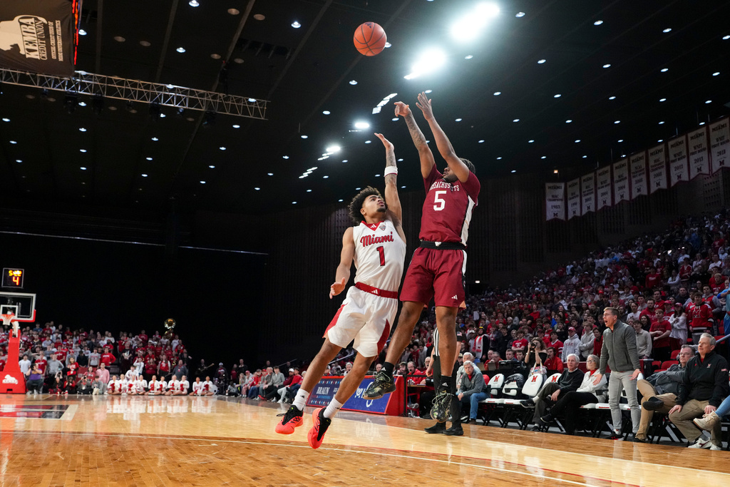 UMass guard K'jei Parker (5) shoots against Miami (Ohio) guard Trey Perry (1) during the first half of an NCAA college basketball game, Tuesday, Jan. 27, 2026, in Oxford, Ohio. (AP Photo/Jeff Dean)