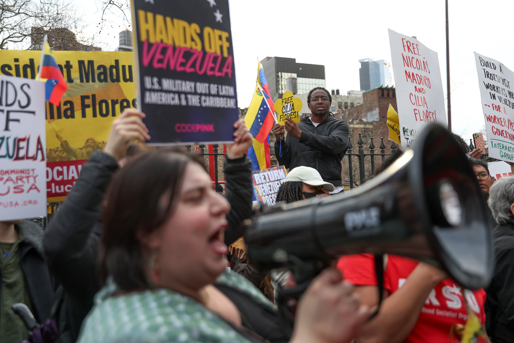 Demonstrators protest outside Manhattan federal court before a pre-trial hearing in former Venezuela President Nicolas Maduro's drug trafficking case, Thursday, March 26, 2026, in New York. (AP Photo/Heather Khalifa)