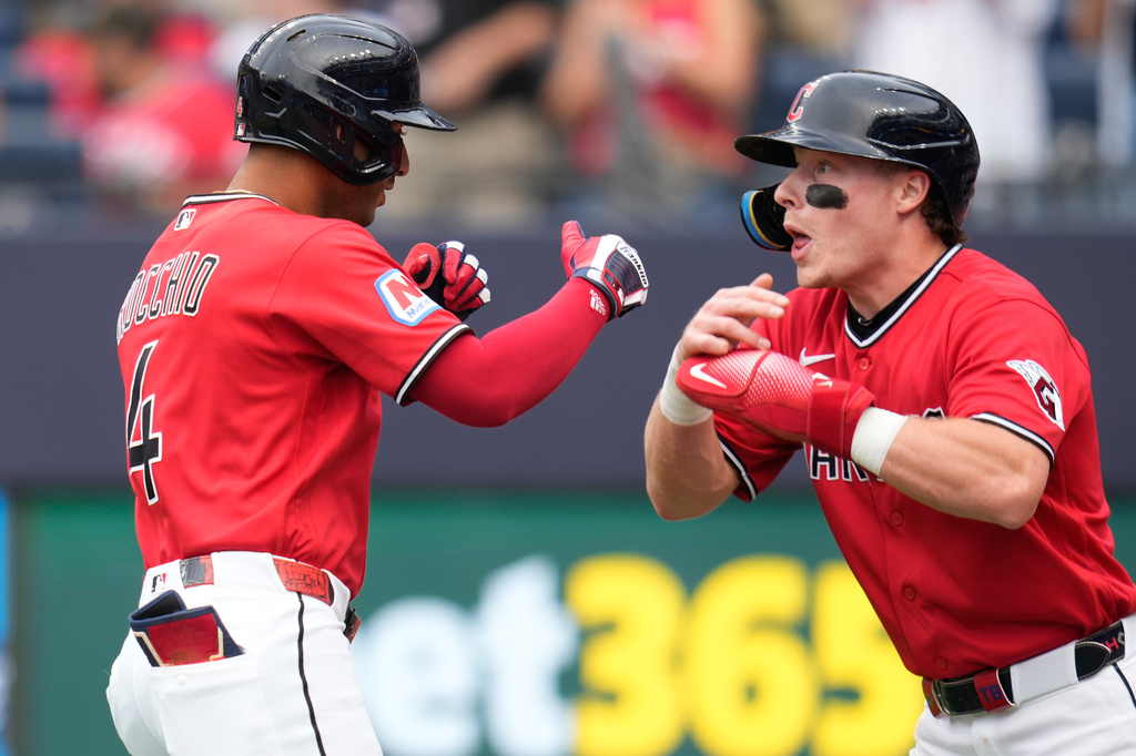 Cleveland Guardians' Brayan Rocchio (4) celebrates with Travis Bazzana, right, after hitting a two-run home run in the first inning of a baseball game against the Minnesota Twins in Cleveland, Monday, July 20, 2026. (AP Photo/Sue Ogrocki)