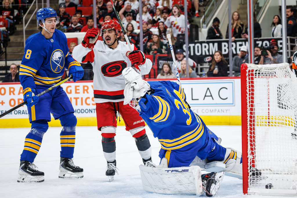 Carolina Hurricanes Seth Jarvis celebrates ahead of Buffalo Sabres Michael Kesselring as the puck crosses the goal line behind goaltender Alex Lyon (34) during the second period of an NHL hockey game in Raleigh, N.C., Saturday, Nov. 8, 2025. (AP Photo/Ben McKeown)