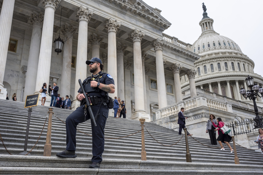 FILE - A U.S. Capitol Police officer stands watch as lawmakers leave the House of Representatives after voting at the Capitol in Washington, Sept. 25, 2024. (AP Photo/J. Scott Applewhite, File)