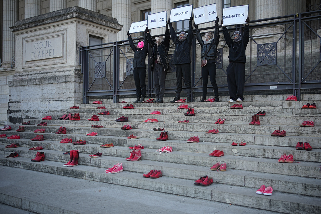 Women hold banners saying '1 in 30 complaints leads to a conviction' during a demonstration on the occasion of the international day for the elimination of violence against women, in Lyon, central France, Saturday, Nov. 22, 2025. (AP Photo/Laurent Cipriani)