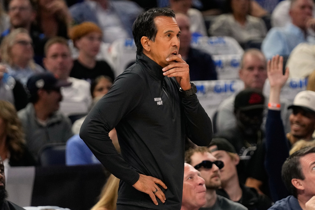 Miami Heat head coach Erik Spoelstra watches his team on the court against the Orlando Magic during the first half of an NBA basketball game, Wednesday, Oct. 22, 2025, in Orlando, Fla. (AP Photo/John Raoux)
