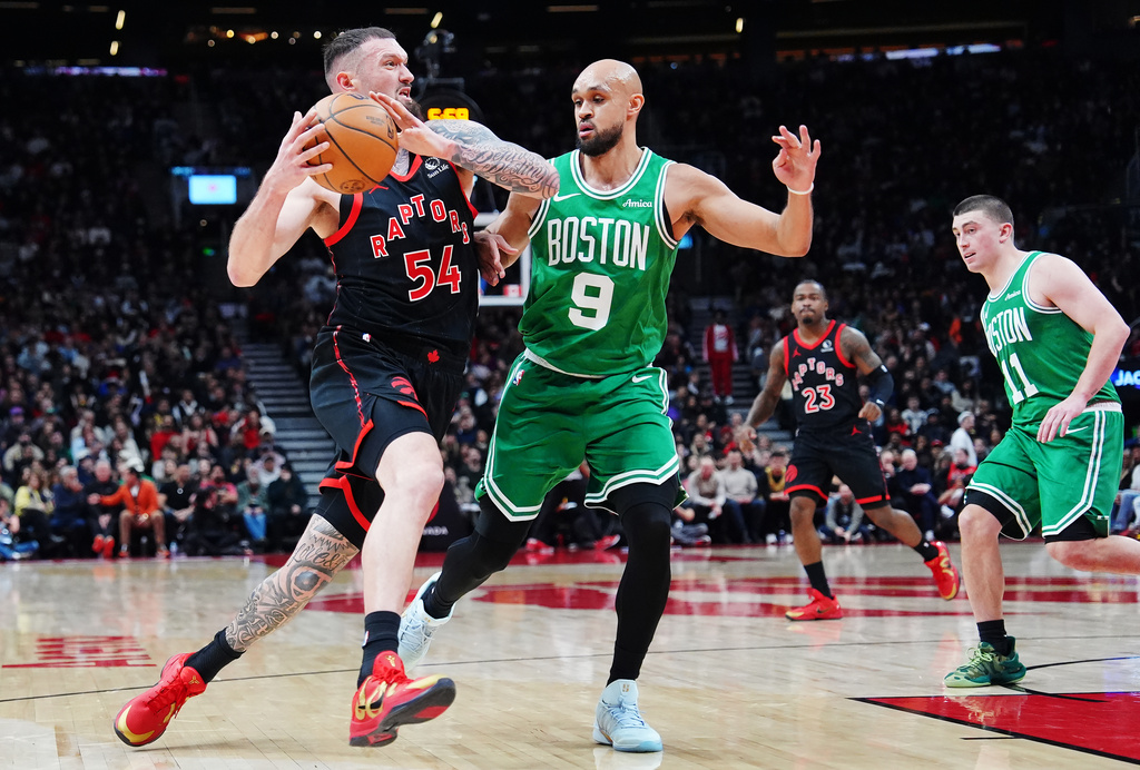 Toronto Raptors' Sandro Mamukelashvili (54) drives as Boston Celtics' Derrick White (9) defends during first-half NBA basketball game action in Toronto, Saturday, Dec. 20, 2025. (Frank Gunn/The Canadian Press via AP)