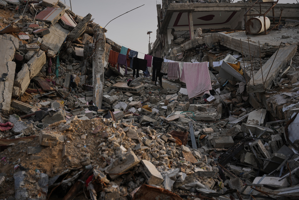 Laundry hangs between the rubble left by Israeli air and ground offensive in Gaza City, Saturday, Nov. 29, 2025. (AP Photo/Abdel Kareem Hana)