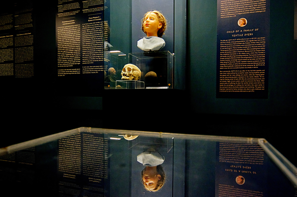 A Roman-era skulls and its facial reconstructions is on display at the Aquincum Museum's exhibition titled "Once we were like you" which showcases characters and the fictional life stories of those who once lived in the bustling Roman settlement of Aquincum, in Budapest, Hungary, Tuesday, July 7, 2026. (AP Photo/Bela Szandelszky)