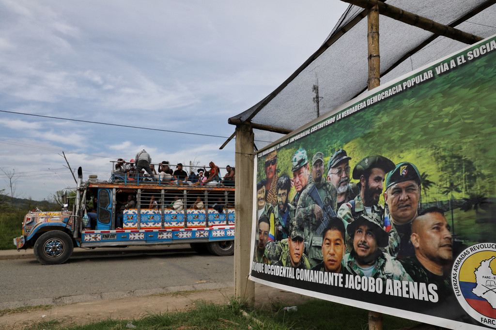 A sign set up by dissidents of the former Revolutionary Armed Forces of Colombia, or FARC, displaying guerrilla leaders stands by a road to Buenos Aires, Cauca, Colombia, Wednesday, May 20, 2026. (AP Photo/Santiago Saldarriaga)