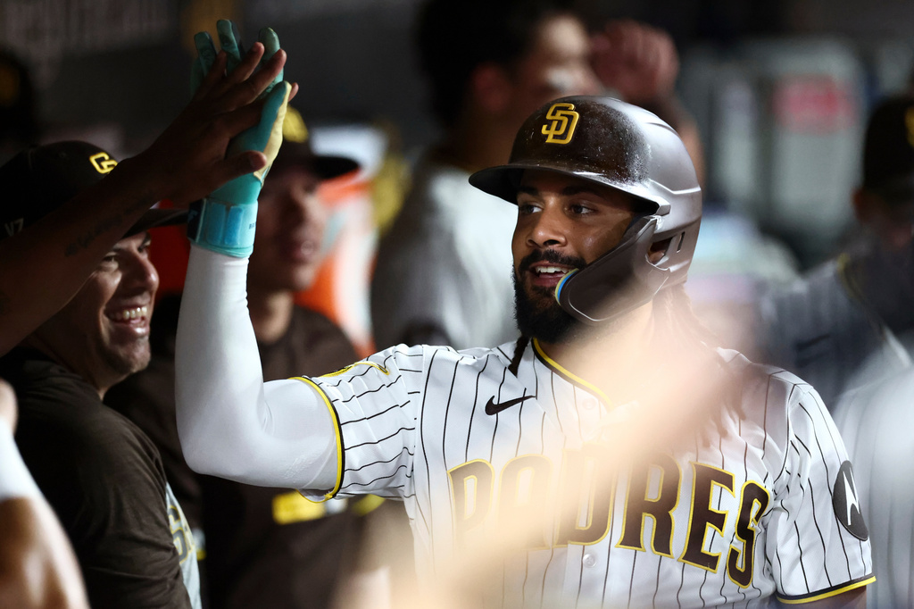 San Diego Padres' Fernando Tatis Jr. celebrates after scoring off Manny Machado's two-run home run in the fourth inning of a baseball game against the Arizona Diamondbacks, Saturday, Sept. 26, 2026, in San Diego. (AP Photo/Karl Anderson)