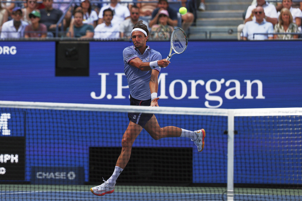 Arthur Rinderknech, of France, returns a shot against Carlos Alcaraz, of Spain, during the fourth round of the U.S. Open tennis championships, Sunday, Aug. 31, 2025, in New York. (AP Photo/Heather Khalifa)