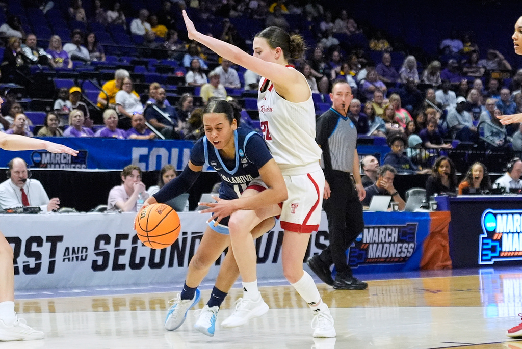 Villanova guard Jasmine Bascoe (11) drives to the basket against Texas Tech guard Bailey Maupin during the first half in the first round of the NCAA college basketball tournament, Friday, March 20, 2026, in Baton Rouge, La. (AP Photo/Gerald Herbert)