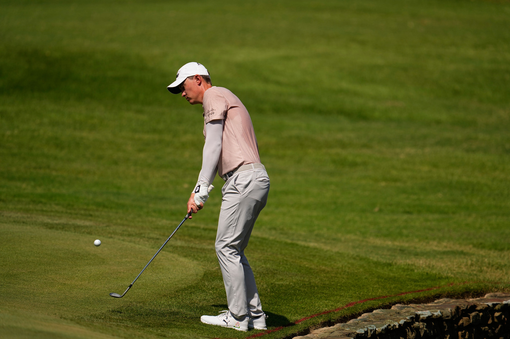 Maverick McNealy chips onto the fourth green during the second round of the St. Jude Championship golf tournament Friday, Aug. 14, 2026, in Memphis, Tenn. (AP Photo/George Walker IV)
