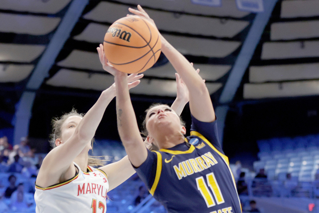 Murray State guard Keslyn Secrist (11) drives against Maryland guard Yarden Garzon (12) during the first half in the first round of the NCAA college basketball tournament, Friday, March 20, 2026, in Chapel Hill, N.C. (AP Photo/Chris Seward)