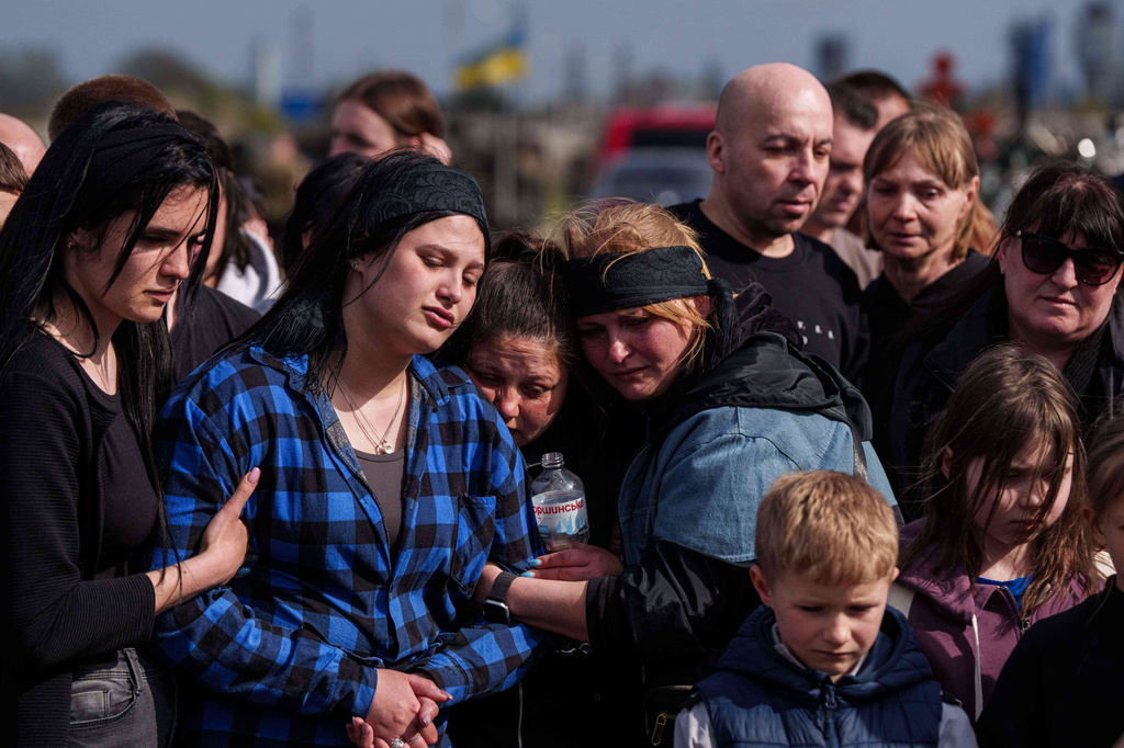 Family members grieve for Bohdan Serhiiev, 8, killed in a Russian drone attack, during a burial service at a cemetery in Cherkasy, Ukraine, Thursday, April 16, 2026. (AP Photo/Evgeniy Maloletka)