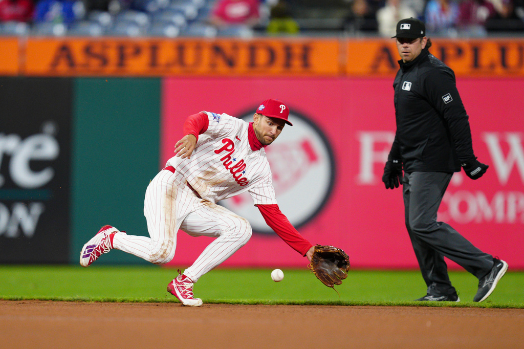 Philadelphia Phillies' Trea Turner, left, fields a groundout hit by Atlanta Braves' Austin Riley during the fourth inning of a baseball game, Sunday, April 19, 2026, in Philadelphia. (AP Photo/Derik Hamilton)