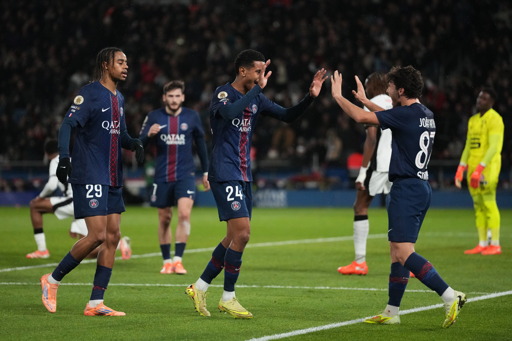 PSG's Senny Mayulu, center, celebrates after scoring his side' second goal during the French League One soccer match between Paris and Rennes in Paris, France, Saturday, Dec. 6, 2025. (AP Photo/Thibault Camus)