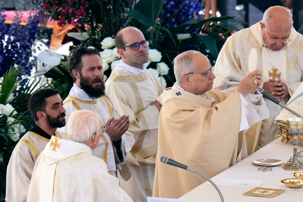 Pope Leo XIV, with Cardinal Kevin Joseph Farrell, chamberlain of the Holy Roman Church, right, and Cardinal Giovanni Battista Re, dean of the College of Cardinals, left, presides over Easter Mass in St. Peter's Square at the Vatican, Sunday, April 5, 2026. (AP Photo/Alessandra Tarantino)