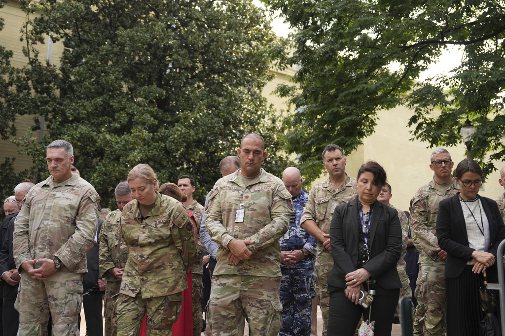 Military staff and guests bow their heads during an observance ceremony on the 25th anniversary of the 9/11 attacks, Friday, Sept. 11, 2026, at the Pentagon in Washington. (AP Photo/Mark Schiefelbein)