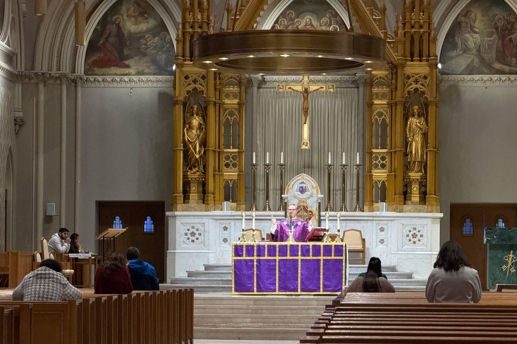 A Roman Catholic priest says a prayer during an afternoon Mass at the Cathedral of Saints Peter and Paul, which serves as the home church of the Roman Catholic Diocese of Providence, on Thursday, March 5, 2026, in Providence, R.I. (AP Photo/Rodrique Ngowi)