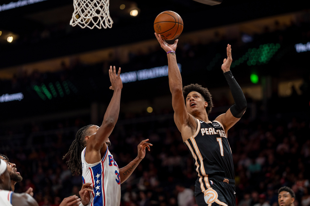 Atlanta Hawks forward Jalen Johnson (1) attempts a basket against Philadelphia 76ers forward Jabari Walker (33) during the first half of an NBA basketball game, Saturday, March 7, 2026, in Atlanta. (AP Photo/Erik Rank)