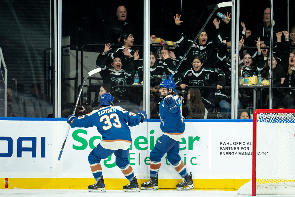 Vancouver Goldeneyes' Sarah Nurse, right, celebrates after her goal against the Toronto Sceptres with teammate Michelle Karvinen (33) during the second period of a PWHL hockey game in Vancouver, British Columbia, Thursday, Jan. 22, 2026. (Ethan Cairns/The Canadian Press via AP)