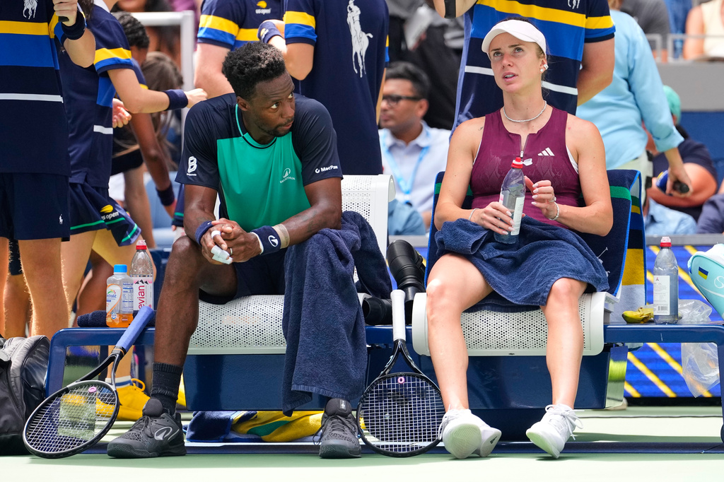 Gael Monfils, of France, left, and Elina Svitolina, of Ukraine, sit courtside during a mixed doubles match at the U.S. Open tennis championships, Tuesday, Aug. 25, 2026, in New York. (AP Photo/Yuki Iwamura)