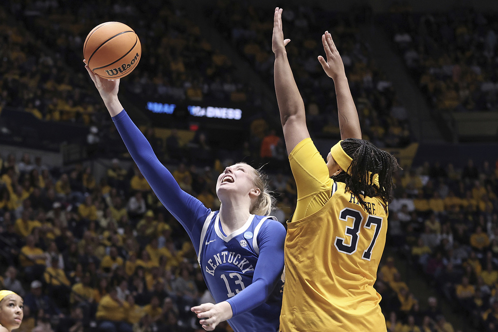Kentucky center Clara Strack (13) is defended by West Virginia forward Celia Riviere (37) in the second half in the second round of the NCAA college basketball tournament, Monday, March 23, 2026, in Morgantown, W.Va. (AP Photo/Kathleen Batten)