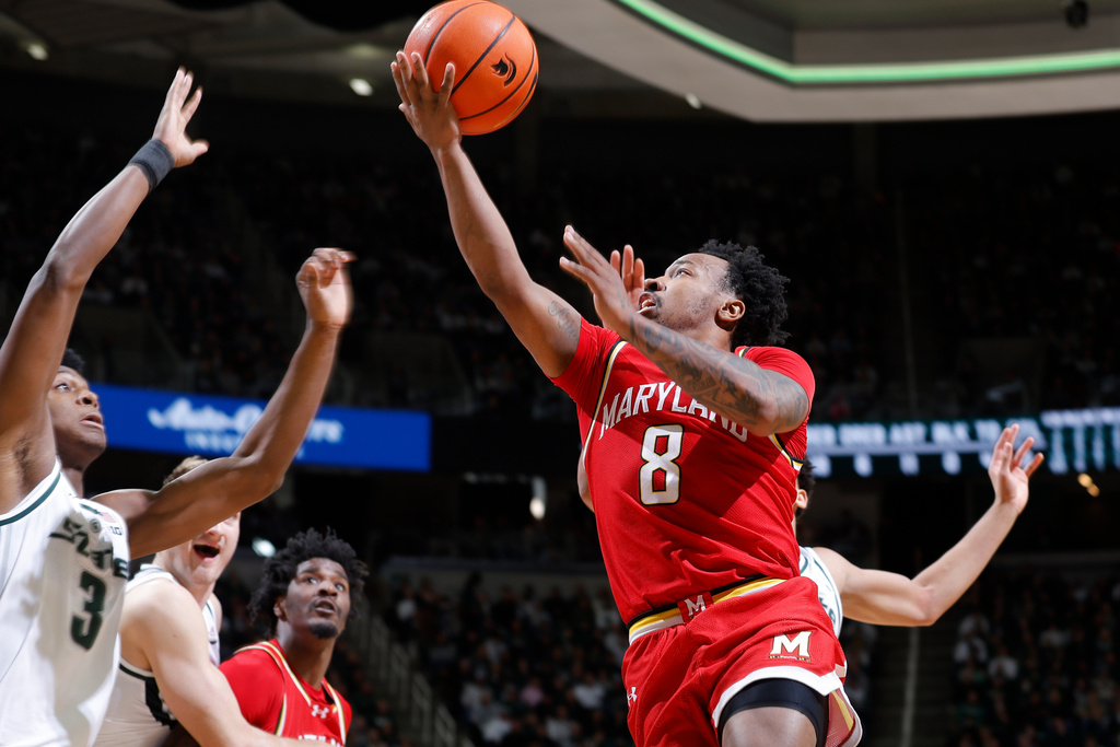 Maryland guard David Coit (8), right, puts up a layup against Michigan State forward Cam Ward (3) during the first half of an NCAA college basketball game, Saturday, Jan. 24, 2026, in East Lansing, Mich. (AP Photo/Al Goldis)