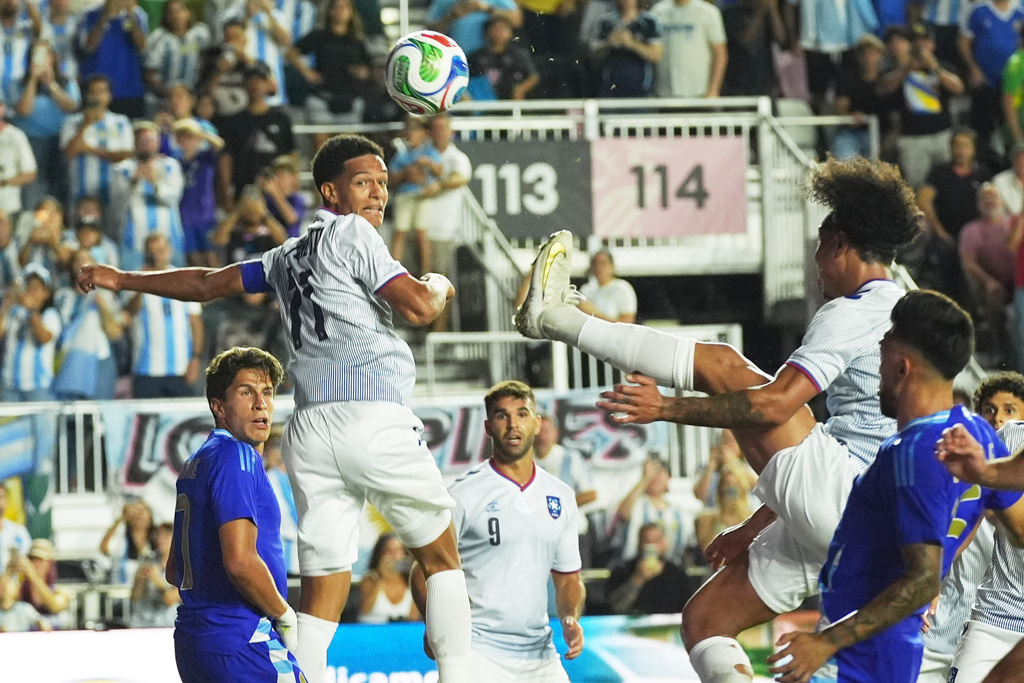Puerto Rico's Isaac Angking (8) kicks the ball during the first half of a friendly soccer match against Argentina, Tuesday, Oct. 14, 2025, in Fort Lauderdale, Fla. (AP Photo/Marta Lavandier)