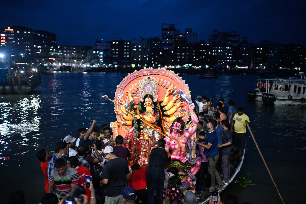 Devotees carry an idol of the Hindu goddess Durga in a boat for immersion in the Buriganga River marking the end of Durga Puja in Dhaka, Bangladesh, Thursday, Oct. 2, 2025. (AP Photo/Mahmud Hossain Opu)